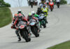 MotoAmerica Supersport races can still be viewed on the MAVTV cable network and also via digital streaming on the FloRacing app. Here, Tyler Scott (70) leads Sam Lochoff (44), Josh Herrin (hidden behind Scott), and the rest of the field in Supersport Race One at Road America. Photo by Brian J. Nelson.