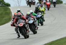 MotoAmerica Supersport races can still be viewed on the MAVTV cable network and also via digital streaming on the FloRacing app. Here, Tyler Scott (70) leads Sam Lochoff (44), Josh Herrin (hidden behind Scott), and the rest of the field in Supersport Race One at Road America. Photo by Brian J. Nelson.