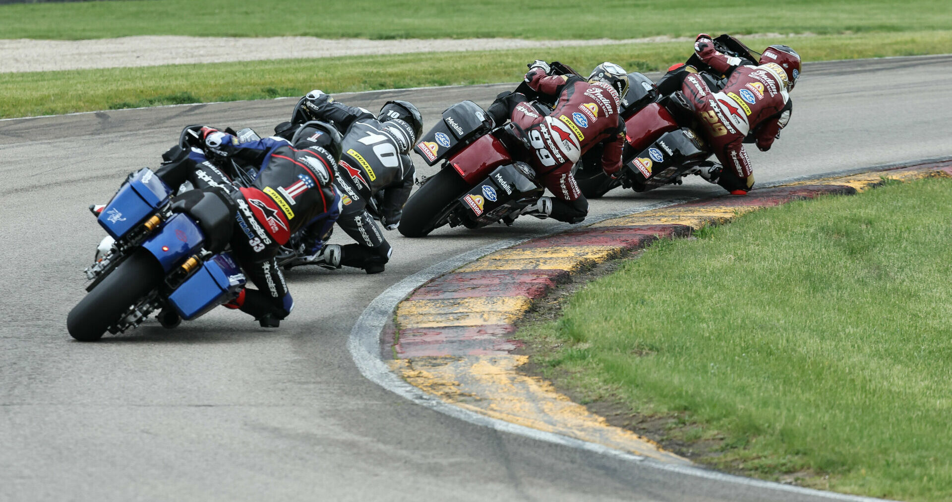 The Mission King Of The Baggers (KOTB) series is back in action this weekend at WeatherTech Raceway Laguna Seca as part of the GEICO Motorcycle MotoAmerica Superbike Speedfest At Monterey. Here, Tyler O'Hara (29) is seen leading Jeremy McWilliams (99), Travis Wyman (10), and Kyle Wyman (1) during the KOTB race at Road America. Photo by Brian J. Nelson.