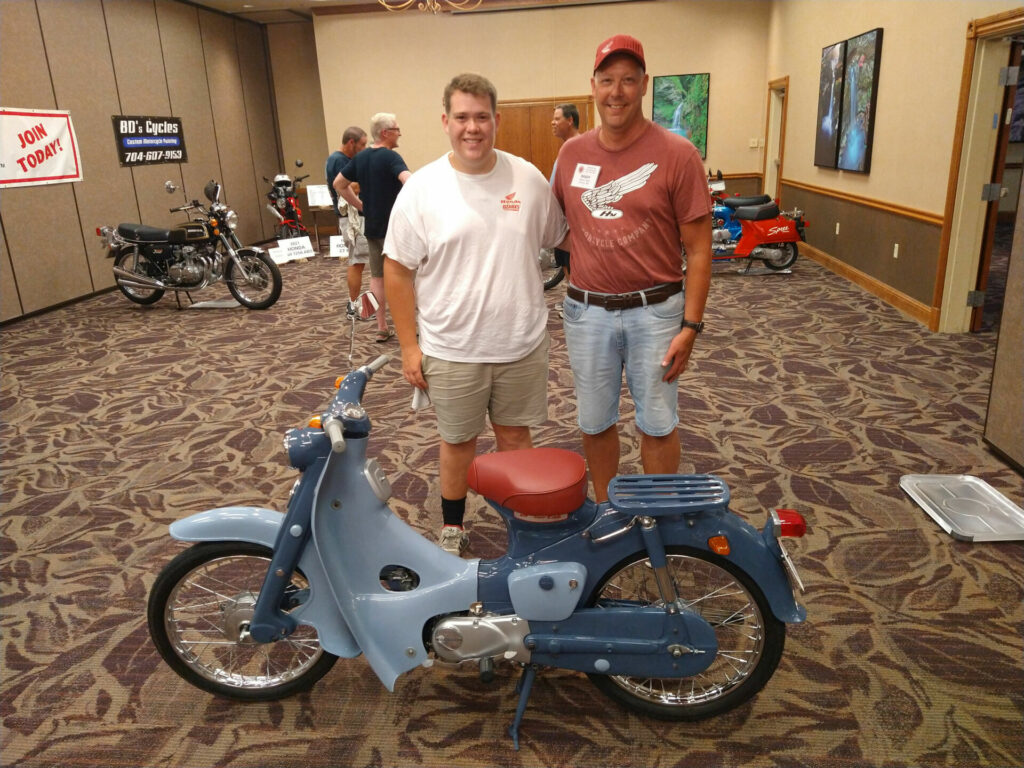 Brady Smith Sr. (right) & Jr. (left), of Joplin, Missouri, with their fully restored 1959 Honda Super Cub - The Milestone Honda Award Winners. Photo by Jon Seidel.