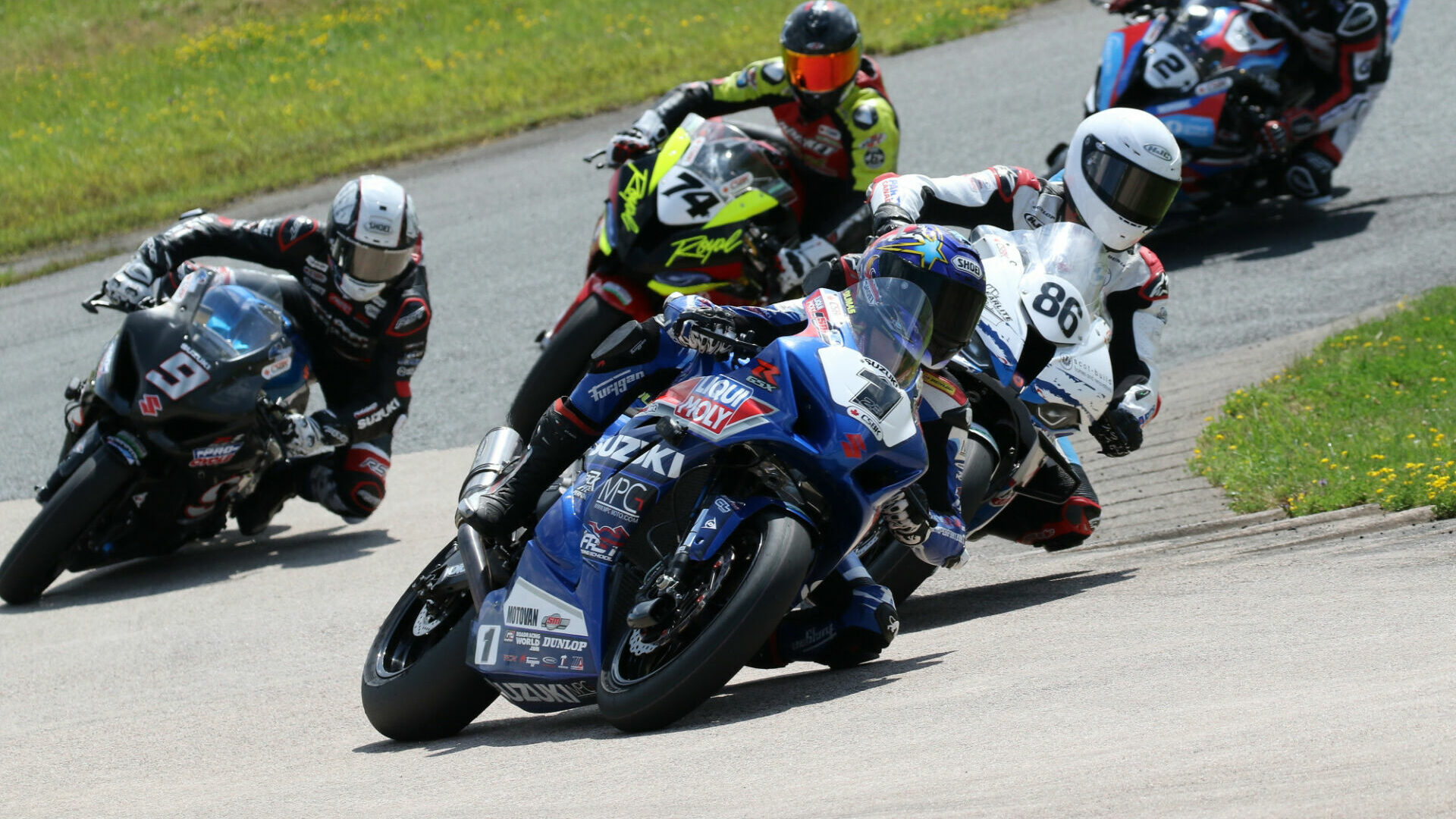 Alex Dumas (1) leads the opening lap of Saturday's Superbike race at Atlantic Motorsport Park. However, Ben Young (86) would go on to claim the victory after Dumas crashed out of the lead at the halfway point. Trevor Daley (9) finished second ahead of Michael Leon (74). Sam Guerin (2) was fourth. Photo by Rob O'Brien, courtesy CSBK/PMP.