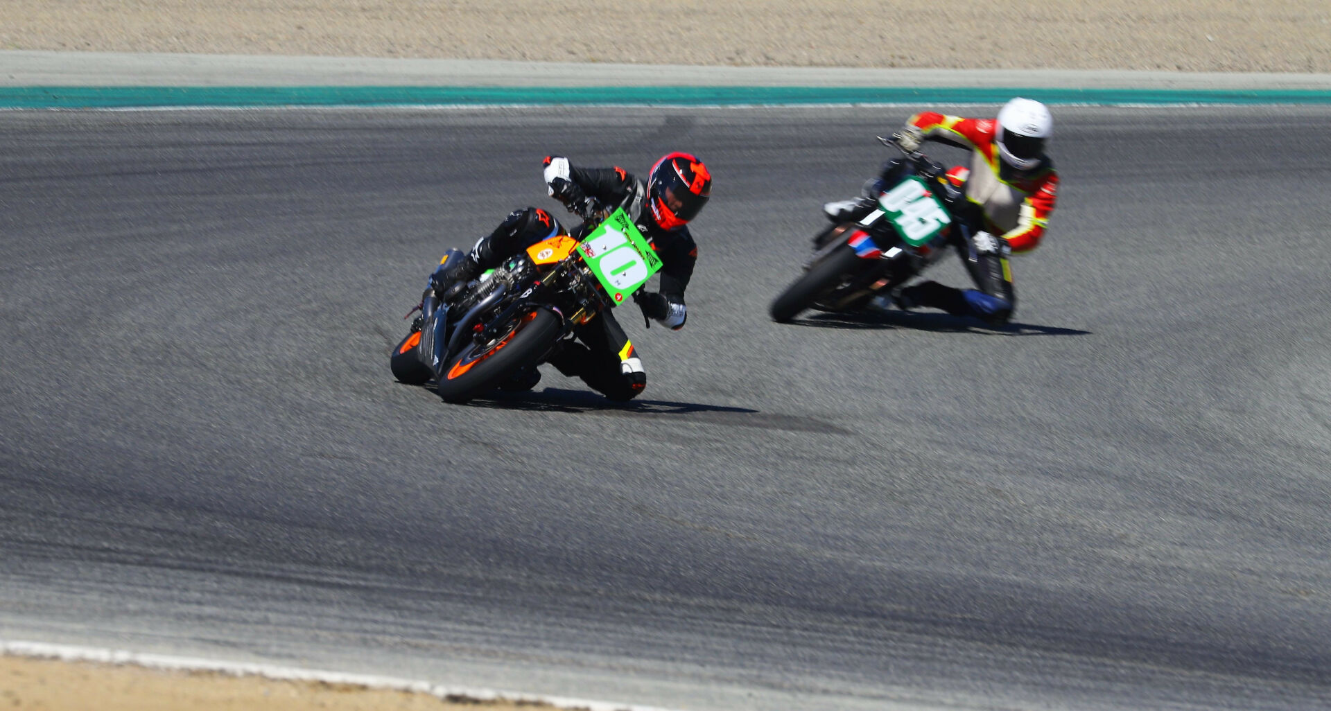 Mark Miller (10M) leading Curtis Adams (045) in a Vintage Cup race at Laguna Seca. Photo by etechphoto.com, courtesy AHRMA.