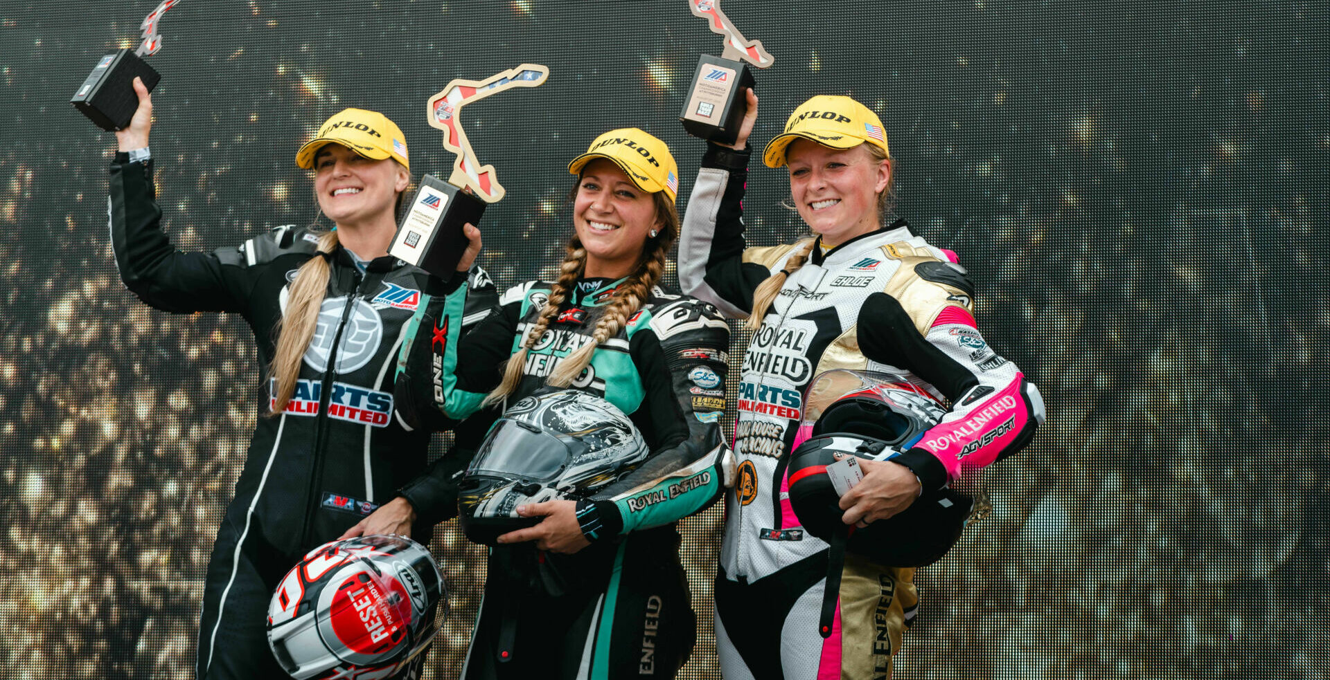 Royal Enfield Build. Train. Race. winner Kayleigh Buyck (center), runner-up Crystal Martinez (left), and third-place finisher Chloe Peterson (right) on the podium at PittRace. Photo courtesy Royal Enfield North America.