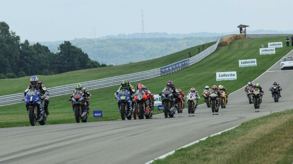 Jake Gagne (1) leads Hector Barbera (80), Cameron Petersen (45), Danilo Petrucci (9) and the rest of the Medallia Superbike pack at the start of Sunday's Superbike race at Pittsburgh International Race Complex. Photo by Brian J. Nelson, photo courtesy MotoAmerica.