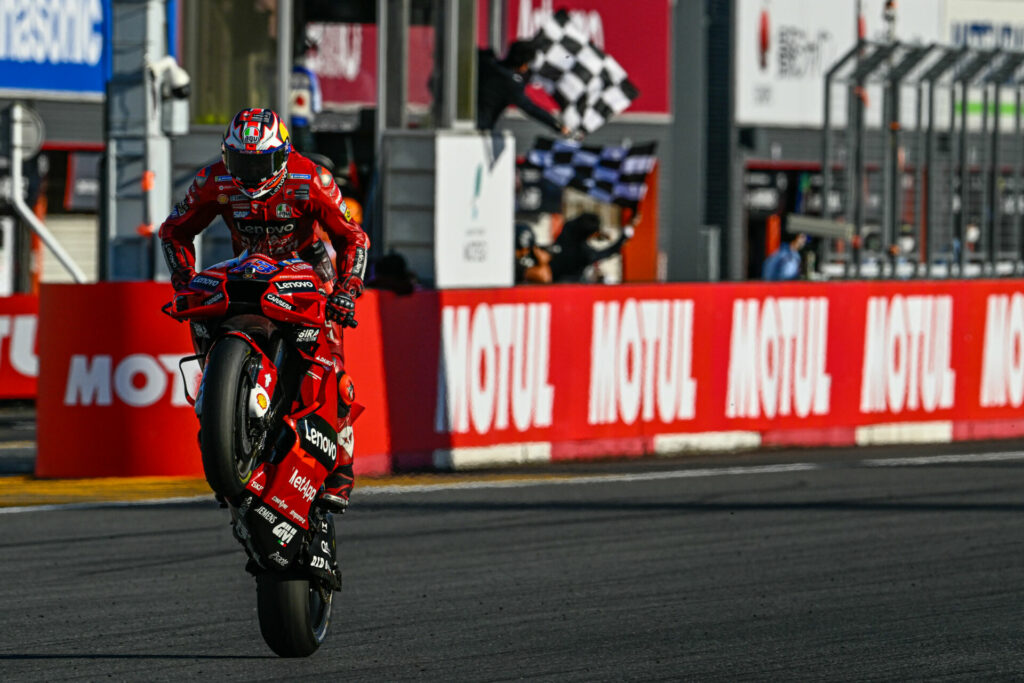 Jack Miller (43) celebrates his victory with a wheelie across the finish line. Photo courtesy Dorna.