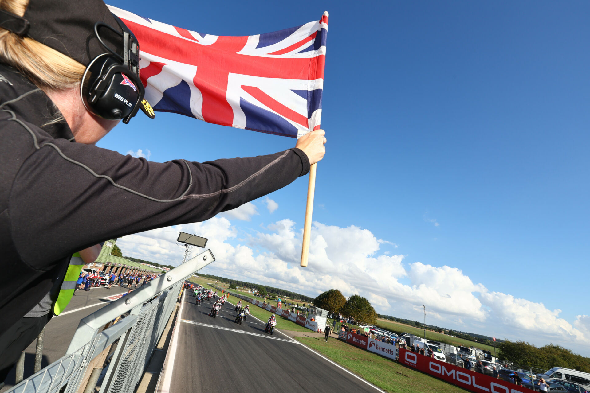 The starter displays the Union Jack, the national flag of the United Kingdom, to the British Superbike field at Snetterton. Photo courtesy MSVR.