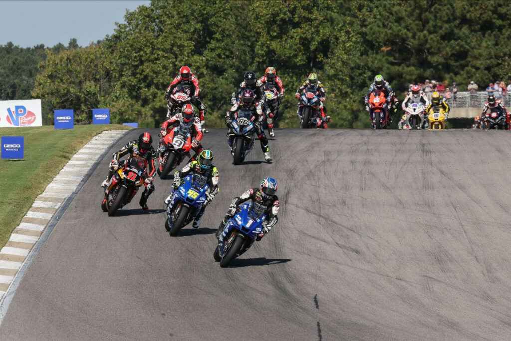 Jake Gagne (1) leads Cameron Petersen (45), Mathew Scholtz (11), Danilo Petrucci (9), PJ Jacobsen (66), and the rest of the field early in Superbike Race One. Photo by Brian J. Nelson, courtesy MotoAmerica.