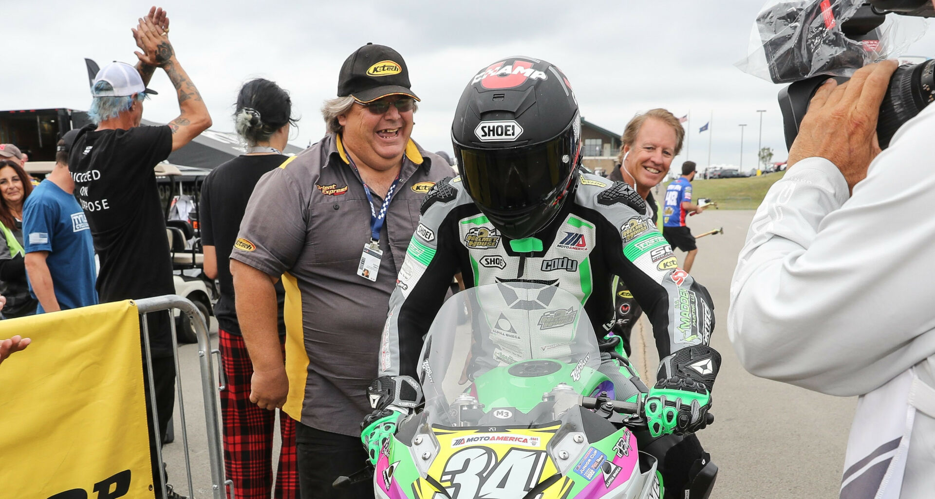 Cody Wyman is congratulated by his suspension tuner Lenny Albin (to Wyman's right) after winning MotoAmerica Junior Cup Race Two at Pittsburgh International Race Complex. Wyman went on to win the 2022 MotoAmerica Junior Cup Championship. Photo by Brian J. Nelson.