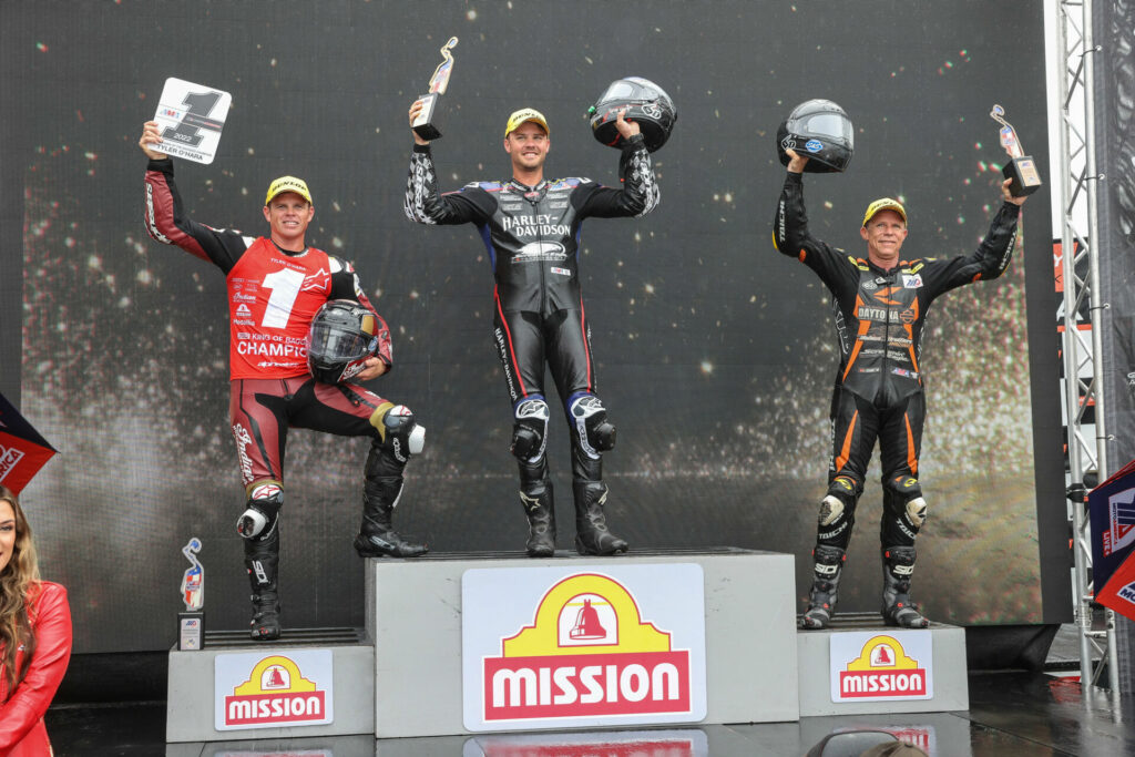 King Of The Baggers race winner Kyle Wyman (center) stands atop the podium with race runner-up and 2022 Champion Tyler O'Hara (left) and Michael Barnes (right), the third-place finisher in the final race. Photo by Brian J. Nelson, courtesy Harley-Davidson.