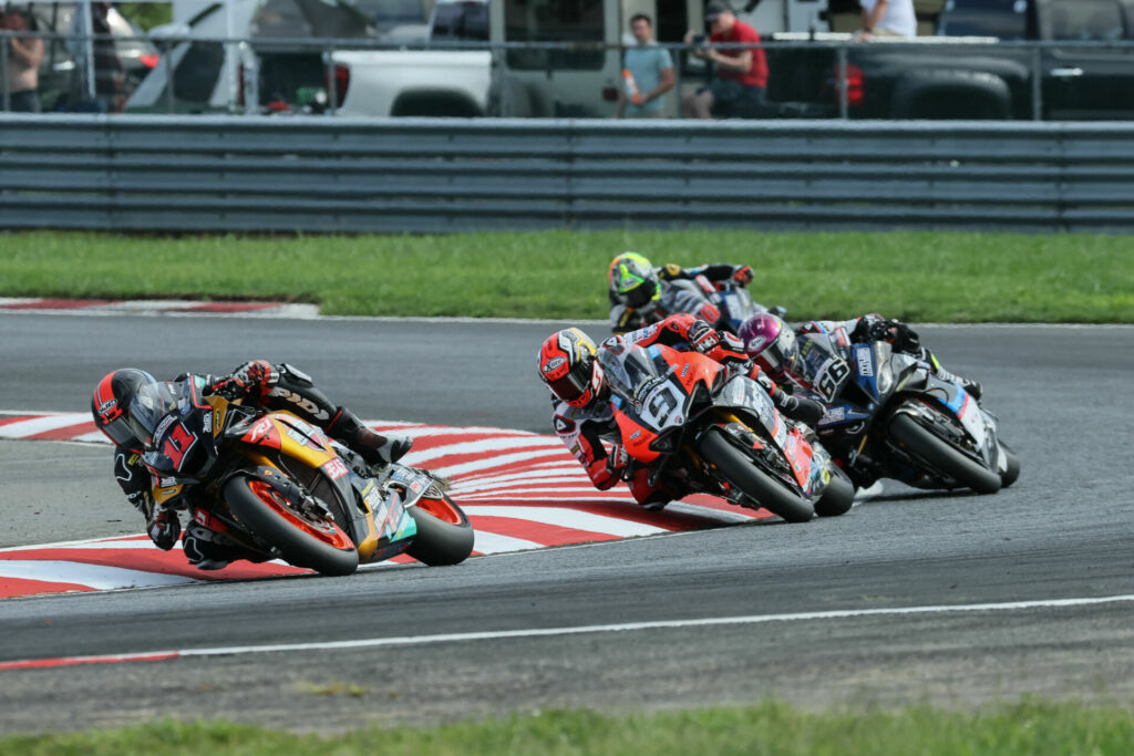 Mathew Scholtz (11) leads Danilo Petrucci (9), PJ Jacobsen (66), and Hector Barbera early in Race One. Photo by Brian J. Nelson, courtesy Westby Racing.