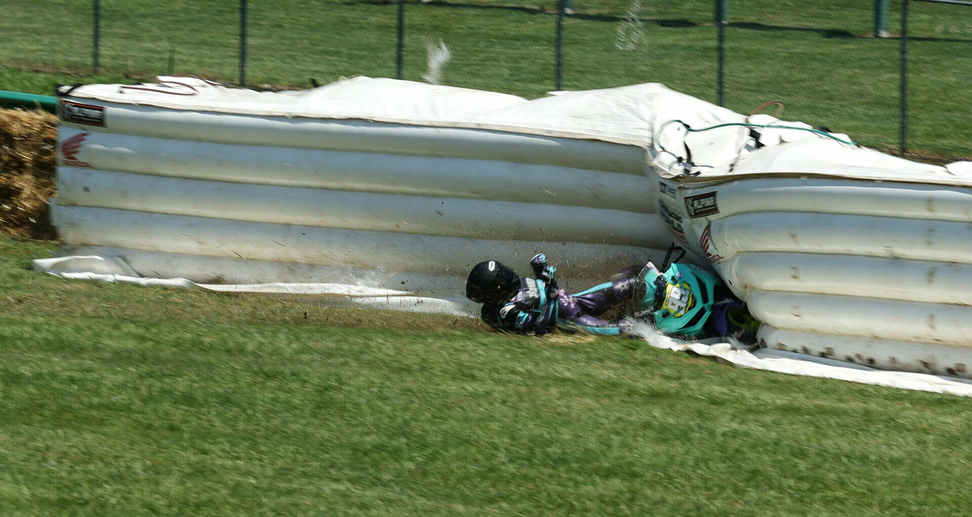 MotoAmerica racer Avery Dreher (99) impacts inflatable Alpina soft barriers provided by the Roadracing World Action Fund. Photo by Brain J. Nelson.