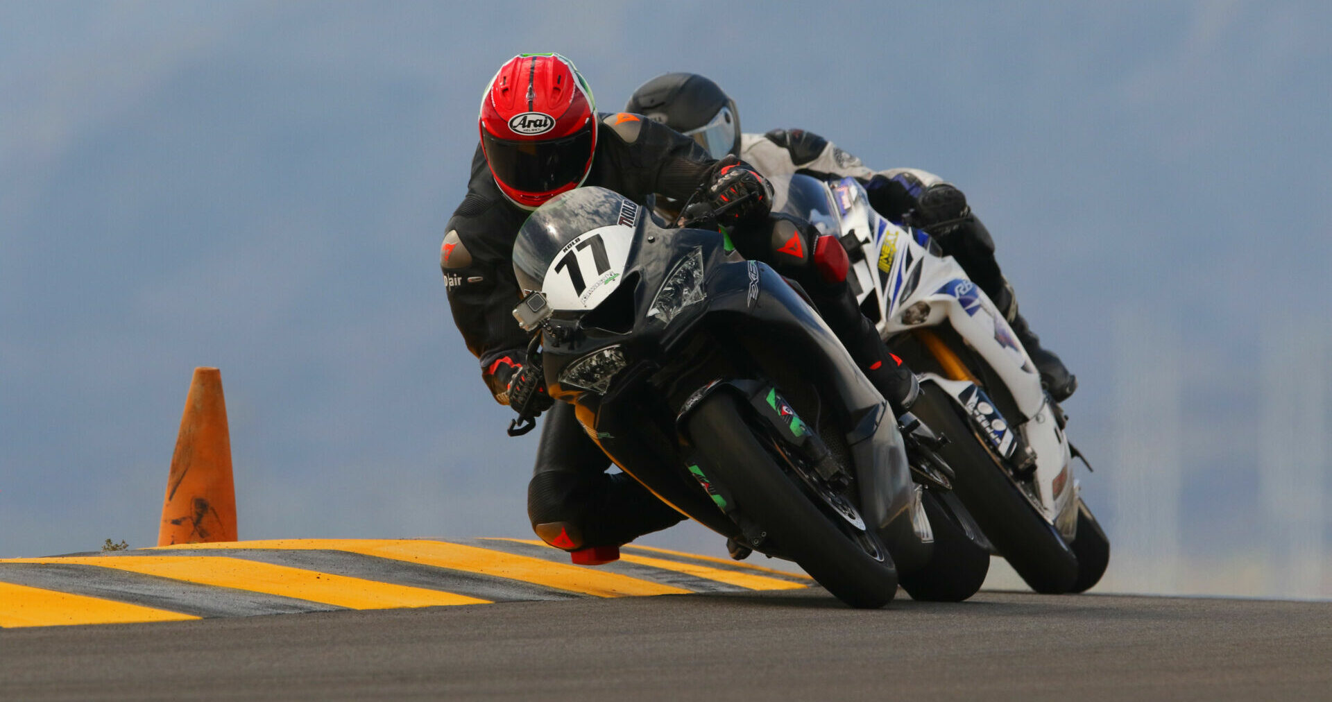 Ana Mata (77) leading fellow CVMA racer Alex Calloway during a recent track day at Chuckwalla Valley Raceway. Photo by CaliPhotography.com, courtesy CVMA.