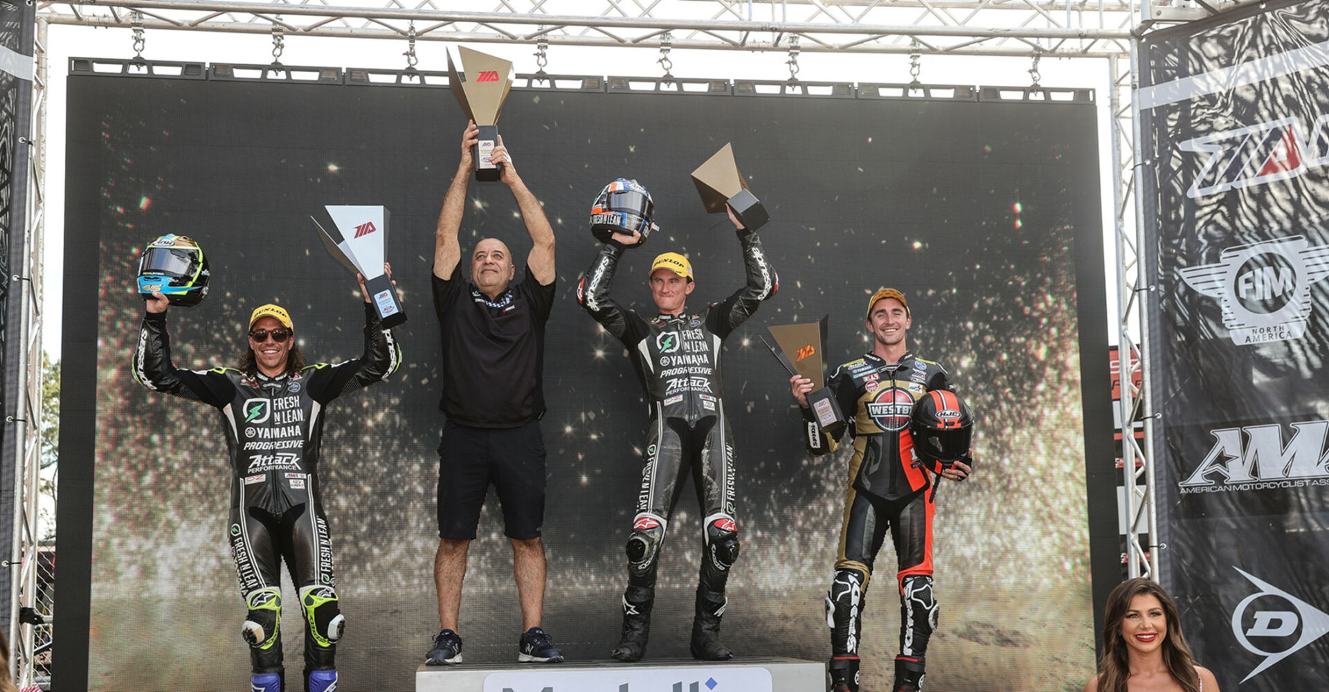Richard Stanboli (second from left) with Cameron Peterson (far left), Jake Gagne (second from right) and Matthew Scholtz (far right) on the MotoAmerica Superbike podium after Race One at New Jersey Motorsports Park. Photo by Brian J. Nelson.