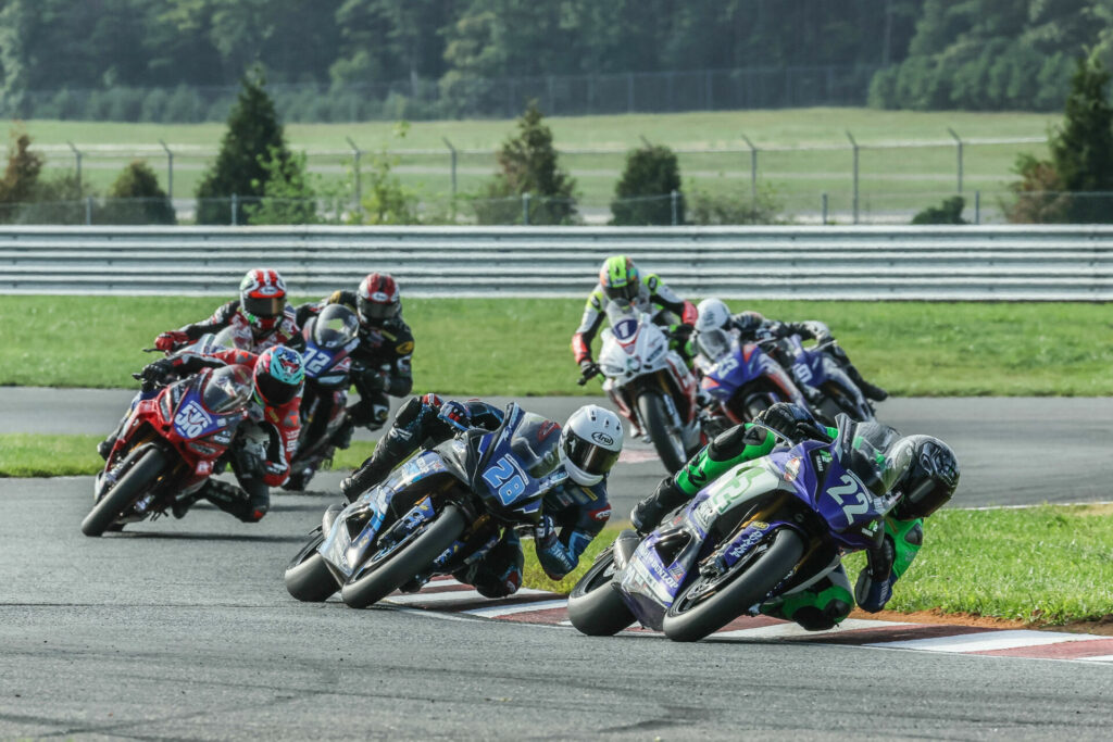 Blake Davis (22) leads Cory Ventura (28) and Anthony Mazziotto (516) in the REV'IT! Twins Cup race at NJMP. Davis won and Ventura crashed out of the battle. Brian J. Nelson.