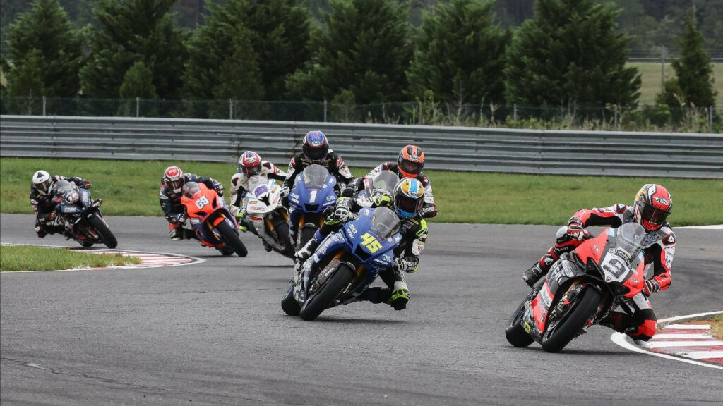 Danilo Petrucci (9) leads Cameron Petersen (45), PJ Jacobsen (behind Petersen), Jake Gagne (1), Ashton Yates (22), Hayden Gillim (69), and Travis Wyman (10) early in MotoAmerica Superbike Race Two. Photo by Brian J. Nelson.