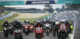 Remy Gardner (on orange KTM) and Jack Miller (on red Ducati) lead a parade of motorcyclists around the Phillip Island Grand Prix Circuit. Photo courtesy Dorna.
