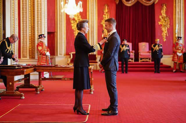 Jonathan Rea (right) receives his MBE from Princess Anne, the "Royal Princess." Photo courtesy Jonathan Rea.