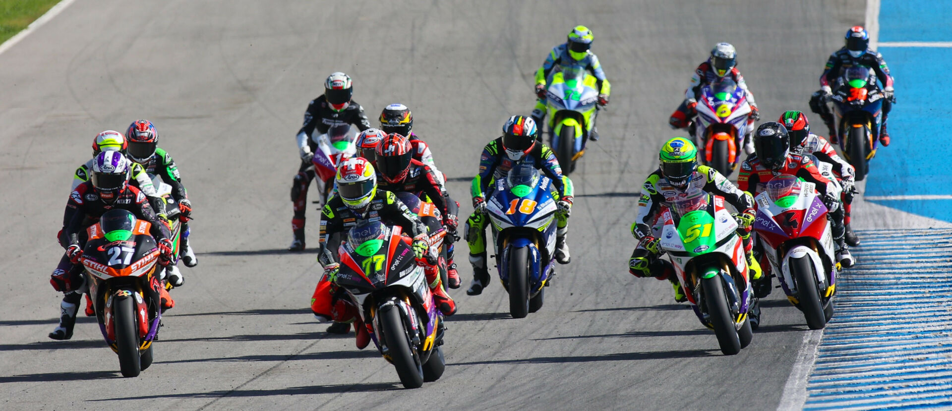 The start of a MotoE race in 2022 with eventual Champion Dominique Aegerter (77) leading on his Energica Ego Corsa electric racebike. Photo courtesy Dorna.