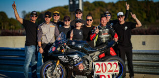 Pirelli Senior Racing Manager Oscar Solis (second from left) joins Army of Darkness' (from left) Geoff May, Anthony Consorte, YT Lechner, Melissa Berkoff, Tim Gooding, Chris Peris, Ben Walters, Sam Fleming, Cody Wyman, and their Yamaha YZF-R1 nicknamed “Gaijin” for a photo on pit lane at Barber Motorsports Park. Photo by Apex Productions LLC, courtesy Army of Darkness.