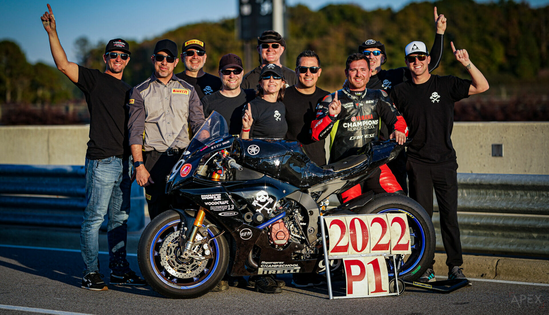 Pirelli Senior Racing Manager Oscar Solis (second from left) joins Army of Darkness' (from left) Geoff May, Anthony Consorte, YT Lechner, Melissa Berkoff, Tim Gooding, Chris Peris, Ben Walters, Sam Fleming, Cody Wyman, and their Yamaha YZF-R1 nicknamed “Gaijin” for a photo on pit lane at Barber Motorsports Park. Photo by Apex Productions LLC, courtesy Army of Darkness.