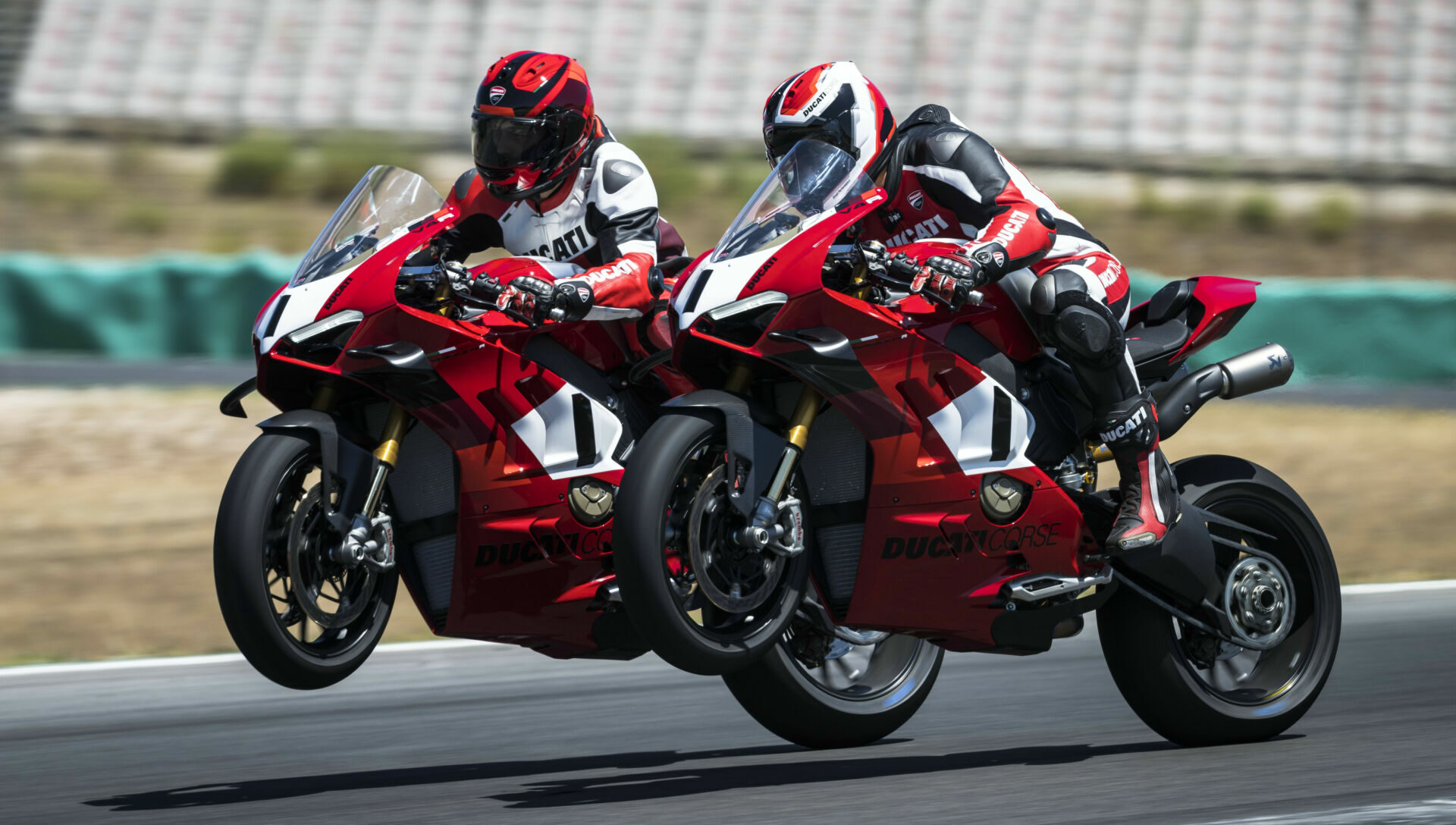 Two Ducati test riders at speed on track on 2023 Panigale V4 R sportbikes. Photo courtesy Ducati.