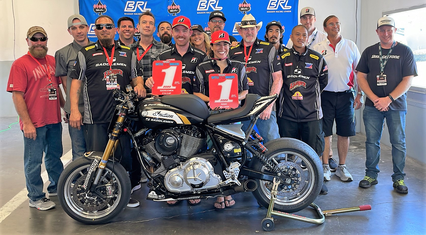 2022 F/S Cup Champion Cory West (left) and 2022 BRL Big Twins Champion Patricia Fernandez (right) with their Bagger Racing League number one plates and their Saddlemen/Lloyd'z Garage team at Daytona. Photo courtesy BRL.