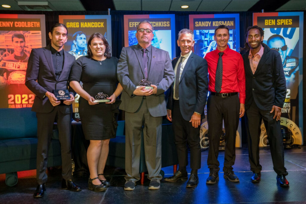 The AMA Motorcycle Hall of Fame Class of 2022: Alec Dare (representing Ben Spies), Nadia DeSimone (daughter of Sandy Kosman), Craig Dove (great-grandson of Effie Hotchkiss), Greg Hancock, Kenny Coolbeth and James Stewart. Photo courtesy AMA.