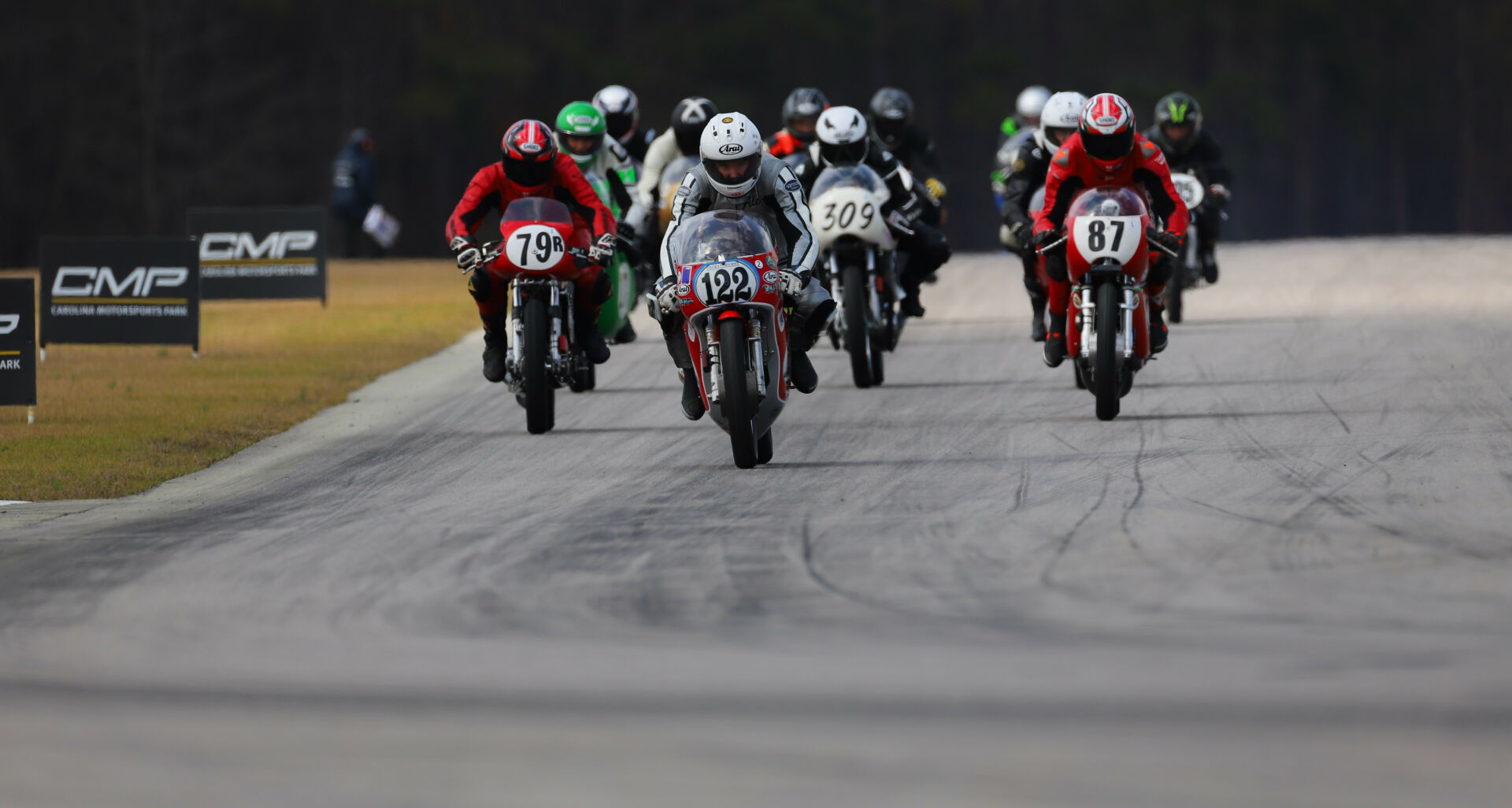 Action from an AHRMA 350 GP race at Carolina Motorsports Park in 2022 with Alex McLean (122) leading Craig Light (79R), Eric Watts (87), and Tim Joyce (309). Photo by etechphoto.com, courtesy AHRMA.