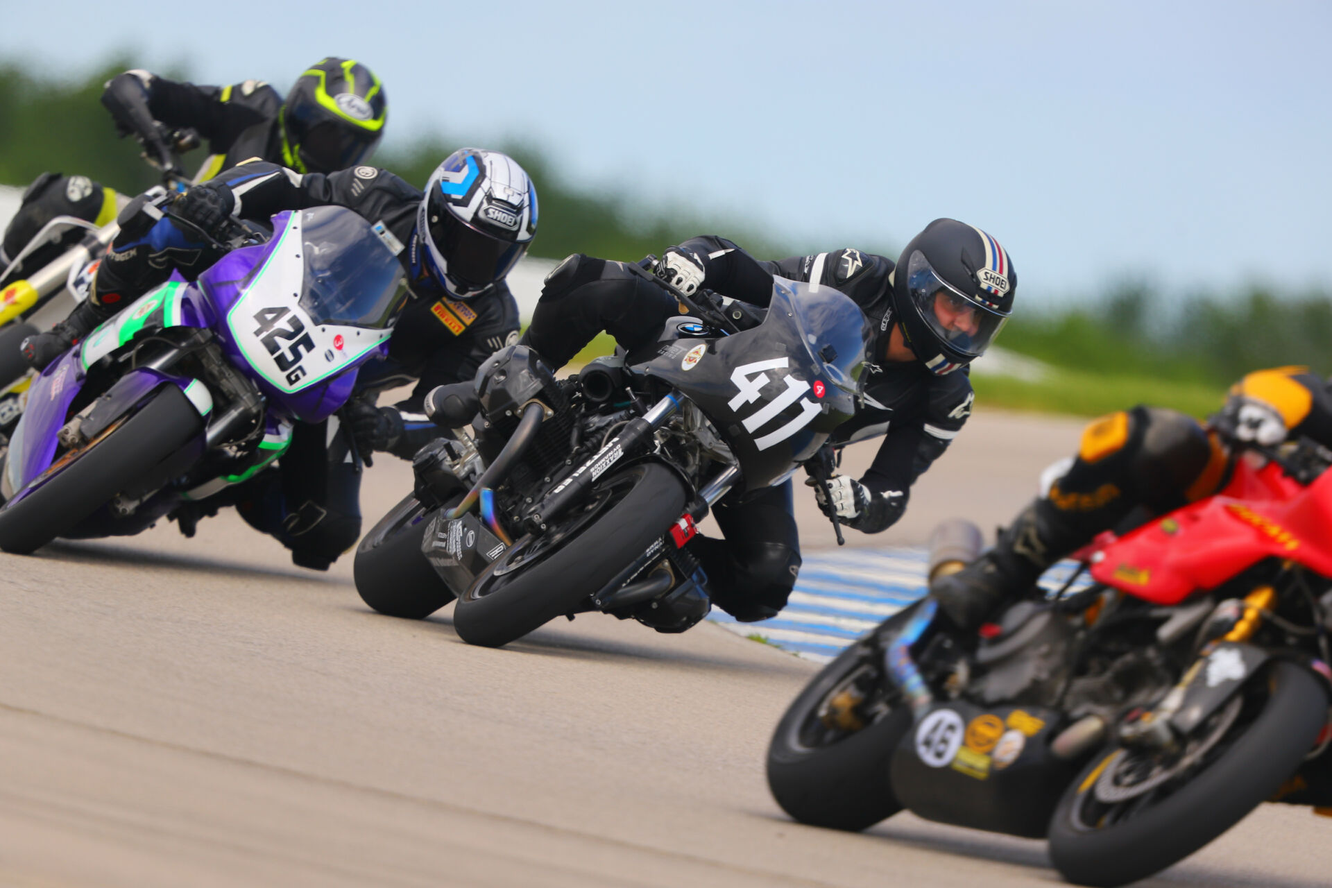 AHRMA racers Bob Robbins (46), Gabriel Figueroa (425G), and James-Derek Mayo (411) in action at Heartland Motorsports Park in 2021. Photo by etechphoto.com, courtesy AHRMA.