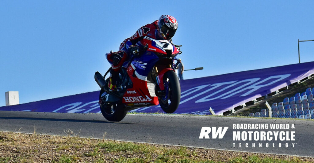 Iker Lecuona (7) wheelies over the crest of a hill at Algarve International Circuit on his factory HRC Honda CBR1000RR-R. Photo by Michael Gougis.