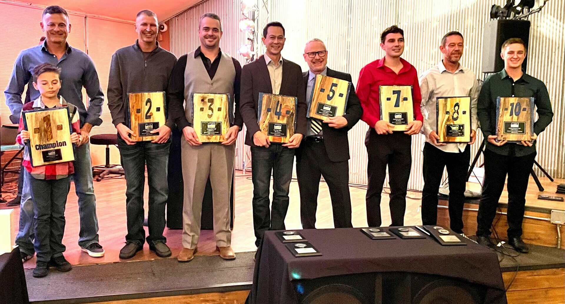 MRA’s top-10 overall finishers in attendance (from left): Mike Applegate and his son Jake, James Wilkerson, Jared Dear, Ken Yee, Kevin Madden, Cameron Lee, Daniel Spurlock, and Justen Behmer. The top-10 plaques were handcrafted and donated by Gus Paw Creations/Chris Nami. Photo by Bob Hasenhundl, courtesy MRA.