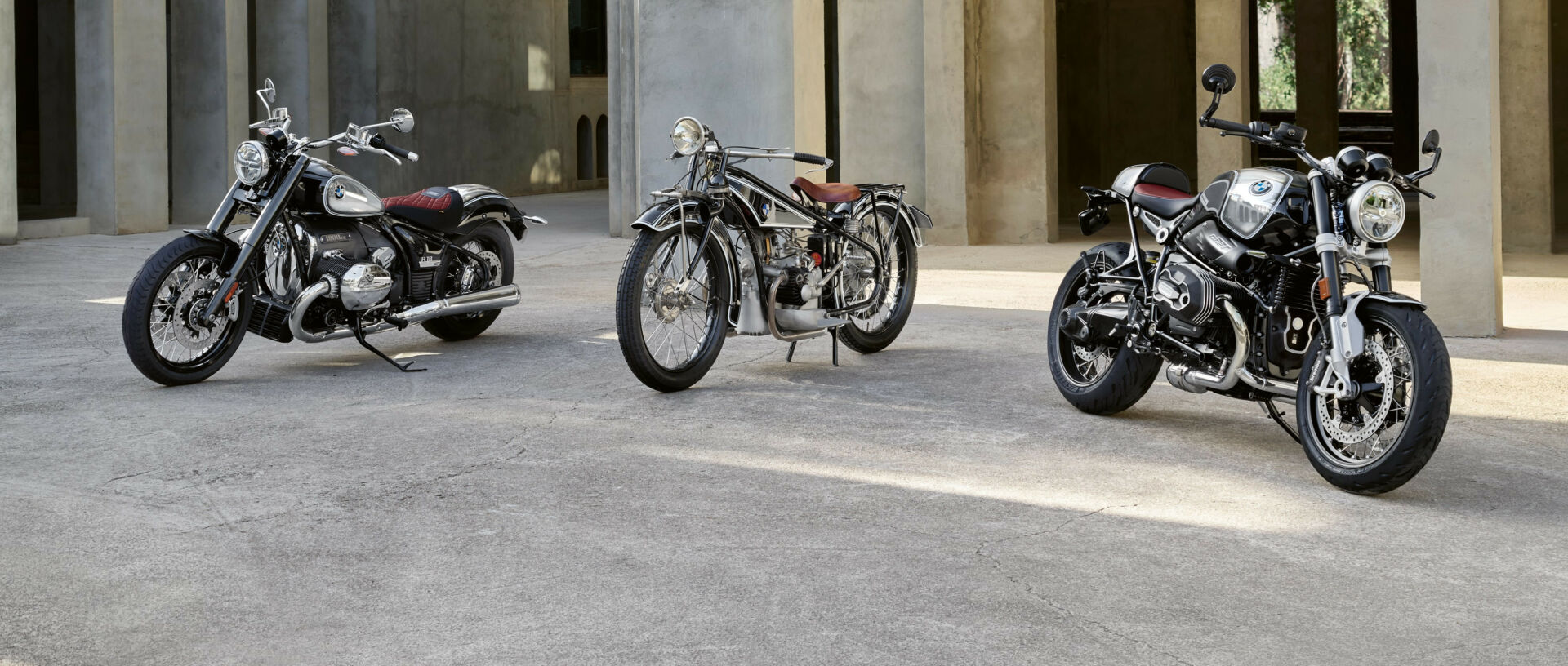 A 1923 BMW R 32 is flanked by a 2023 R 18 100 Year Edition (left) and a 2023 R nineT 100 Year Edition (right). Photo courtesy BMW Motorrad.