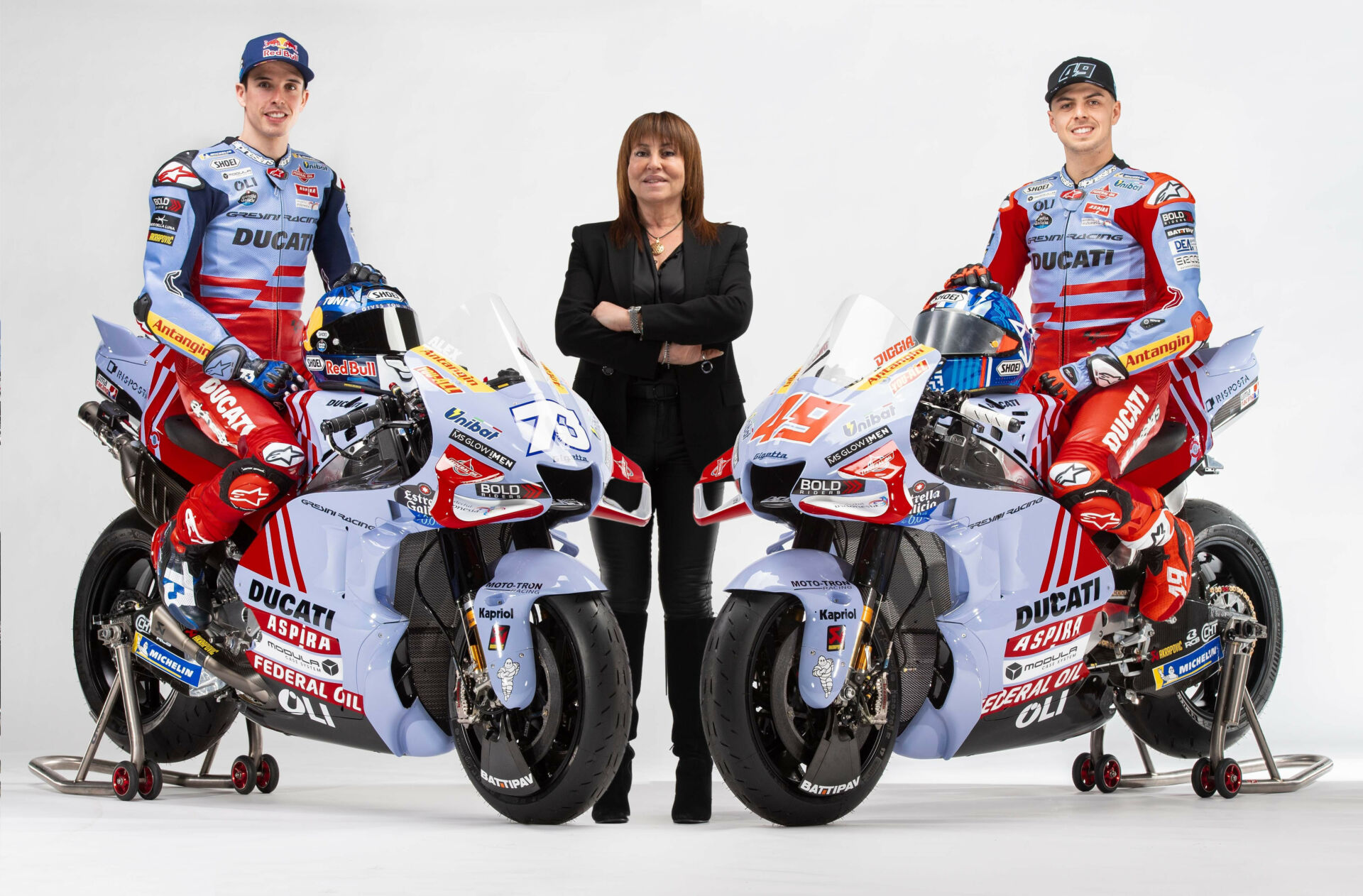 Team Gresini Racing MotoGP owner Nadia Padovani (center) with riders Alex Marquez (left) and Fabio Di Giannantonio (right) and their Ducati Desmosedici GP22 racebikes. Photo courtesy Gresini Racing.