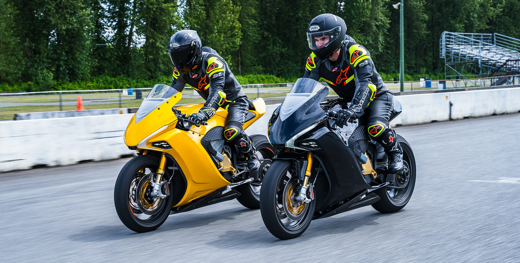 Two Damon electric motorcycle prototypes on a racetrack. Photo courtesy Damon Motors.