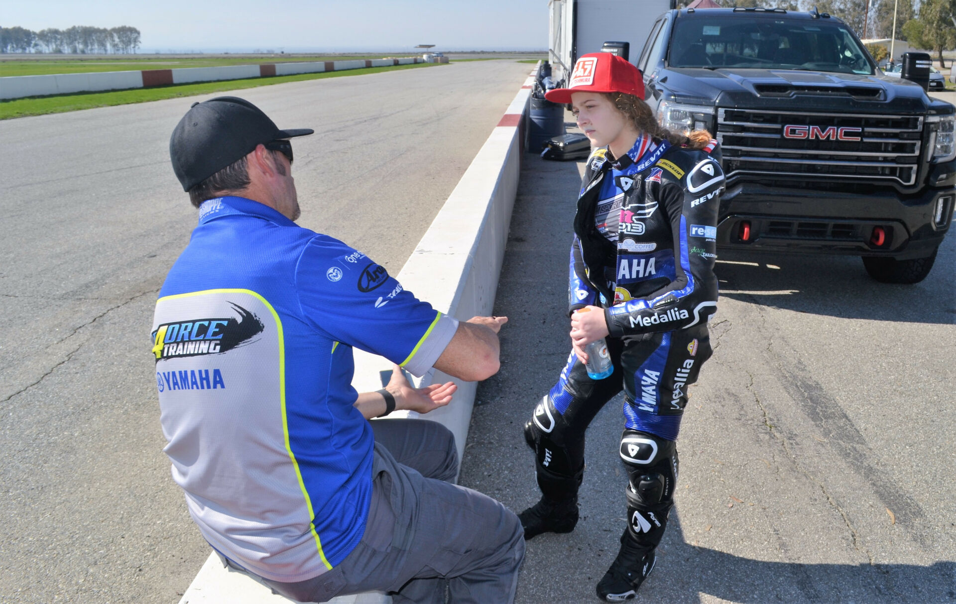 Four-time AMA Superbike Champion and rider coach Josh Hayes (left) works with MP13 Racing Yamaha MotoAmerica Twins Cup racer Kayla Yaakov during a test at Buttonwillow. Photo by David Swarts.