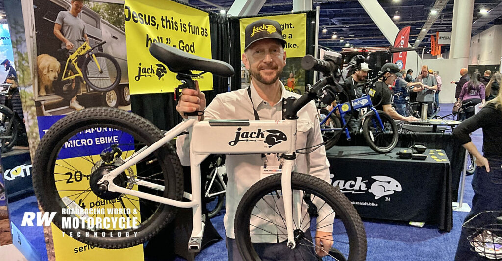 JackRabbit CEO Jason Kenagy holds up the JackRabbit. It weighs 24 pounds, gets 10 miles on a charge and can carry a spare battery under the seat. Photo by Michael Gougis.