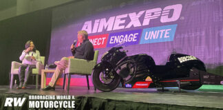 Angelle Sampey discusses her Pro Stock drag racing career with Suzuki's Kerry Graeber at the AIM Expo in Las Vegas. Photo by Michael Gougis.