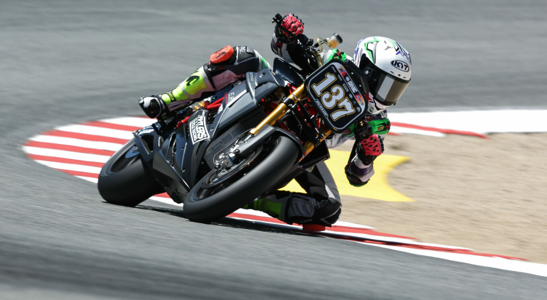 Stefano Mesa (137) at speed on his Tytlers Cycle Racing Energica at Laguna Seca in 2022. Photo courtesy Energica.