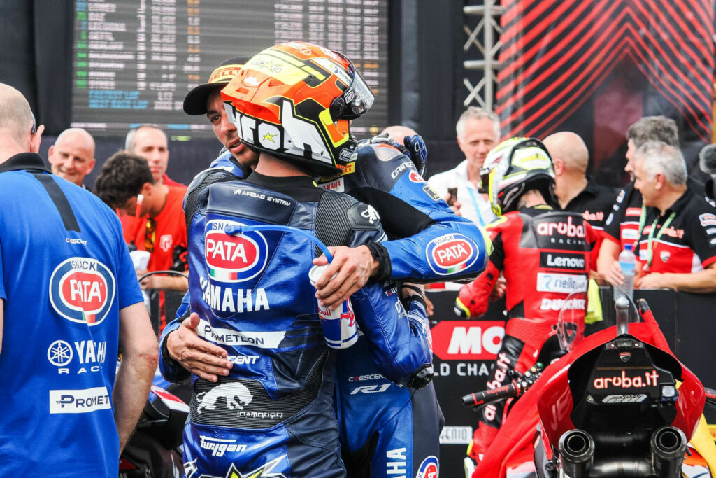 Andrea Locatelli (back to the camera) with teammate Toprak Razgatlioglu in Parc Ferme. Photo courtesy Dorna.