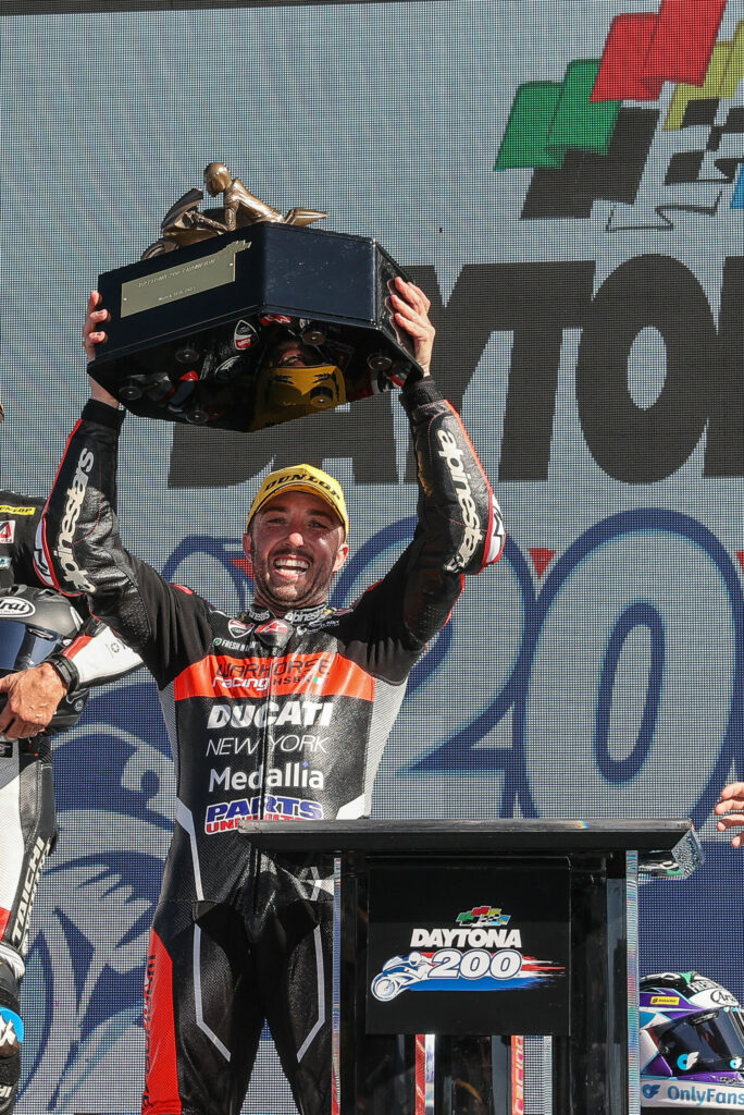 Josh Herrin on the podium with the Daytona 200 winner's trophy. Photo by Brian J. Nelson, courtesy Ducati.