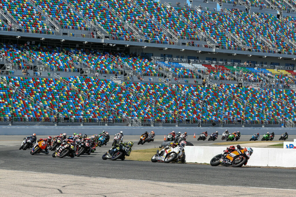 The original start of the 81st Daytona 200 with Josh Herrin (1) leading Danny Eslick (69), PJ Jacobsen (66), Richie Escalante (54), Tyler Scott (70), Geoff May (99), and the rest through Turn One. Photo by Brian J. Nelson.