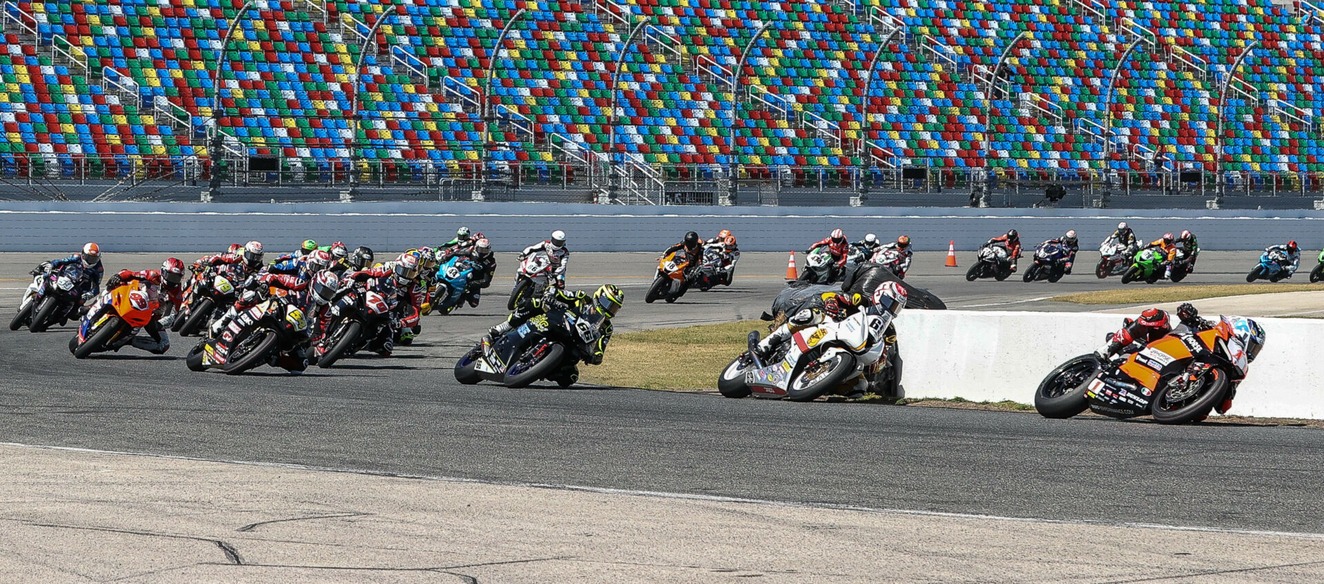 The original start of the 81st Daytona 200 with Josh Herrin (1) leading Danny Eslick (69), PJ Jacobsen (66), Richie Escalante (54), Tyler Scott (70), Geoff May (99), and the rest through Turn One. Photo by Brian J. Nelson.