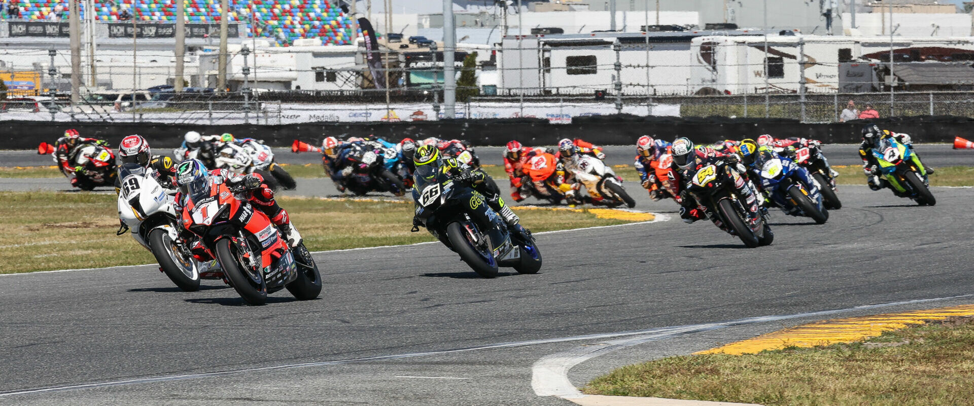 Josh Herrin (1), Danny Eslick (69), PJ Jacobsen (66), Richie Escalante (54), Cameron Petersen (45), Josh Hayes (4), and the rest of the field during the start of the 81st Daytona 200. Photo by Brian J. Nelson.