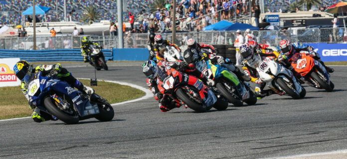 Late in the restarted 81st Daytona 200, Cameron Petersen (45) leads Josh Herrin (1), Josh Hayes (4), Brandon Paasch (96), Hayden Gillim (95), Geoff May (behind Paasch), Teagg Hobbs (behind Hayes), Danny Eslick (69), Blake Davis (behind Eslick), PJ Jacobsen (66), and the rest. Photo by Brian J. Nelson.