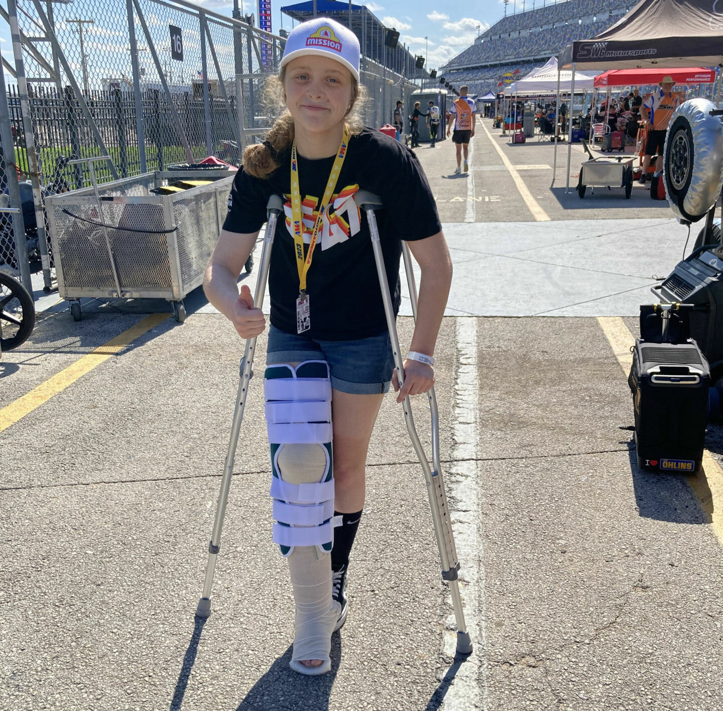 Kayla Yaakov on crutches on pit lane at Daytona International Speedway. Photo by John Ulrich.