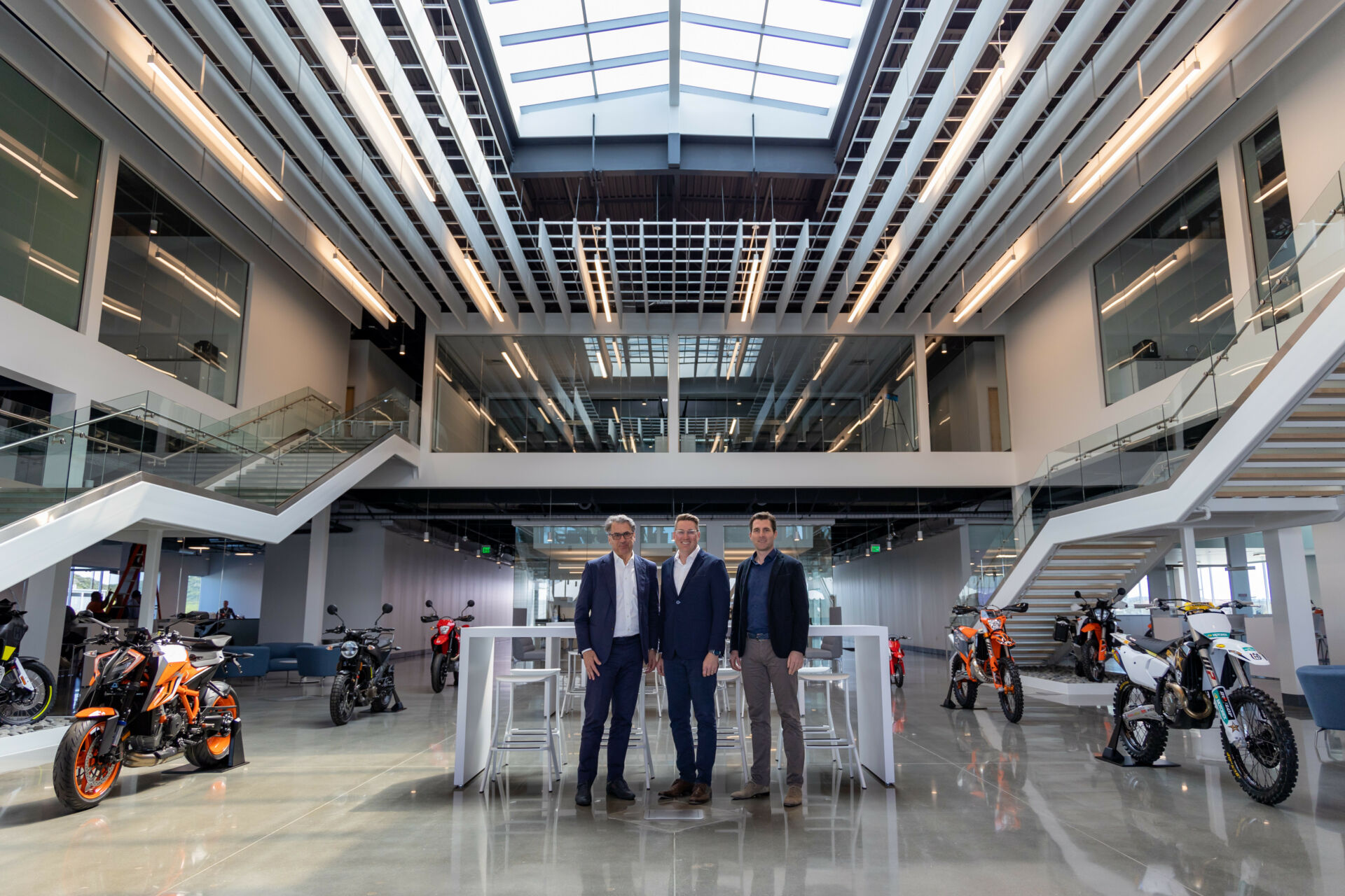 (From left) Stefan Pierer, PIERER Mobility AG CEO; John Hinz, CEO of KTM North America, Inc. and PIERER New Mobility North America, Inc.; and Florian Kecht, a Member of the Executive Board of KTM AG in the lobby of the new KTM North America Inc./PIERER New Mobility North America headquarters in Murrieta, California. Photo courtesy KTM North America.