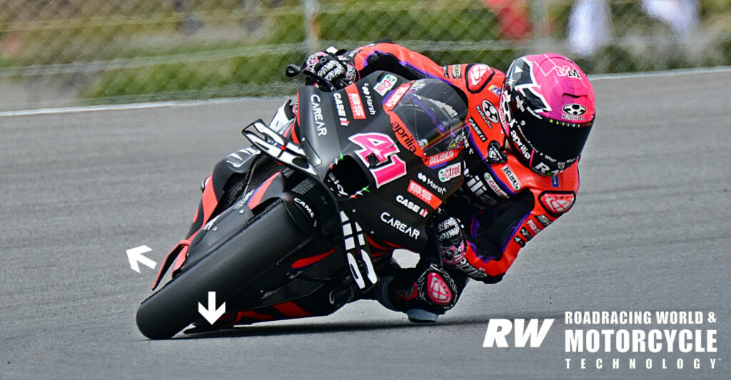 Aprilia Front Wheel: The front wheel winglets on the Aprilia RS-GP generate a small amount of drag but no downforce mid-corner on the upper part of the bike (left arrow designates direction of force generated by appendage) but push the front tire directly into the pavement when the bike is at maximum lean angle (right arrow). Aleix Espargaro told Roadracing World that the bike is fast, very fast, in the daunting, high-speed Turn 15 that leads onto the main straight at the Algarve. Photo by Michael Gougis.