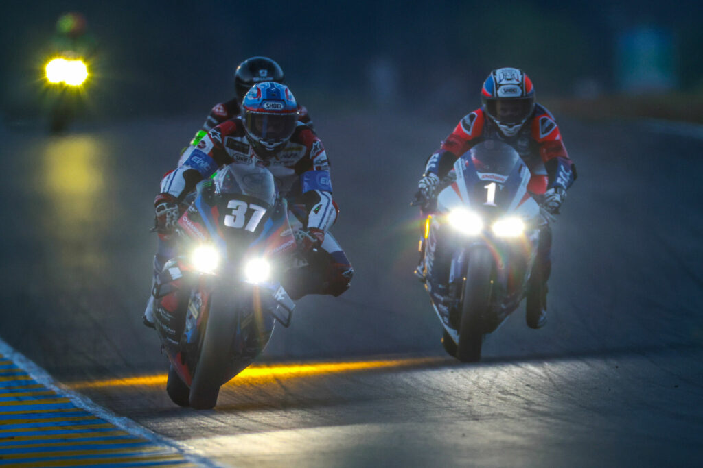 BMW Motorrad World Endurance Team (37) and  F.C.C. TSR Honda France (1) race for position in the darkness at the 24 Hours of Le Mans. Photo courtesy FIM EWC.