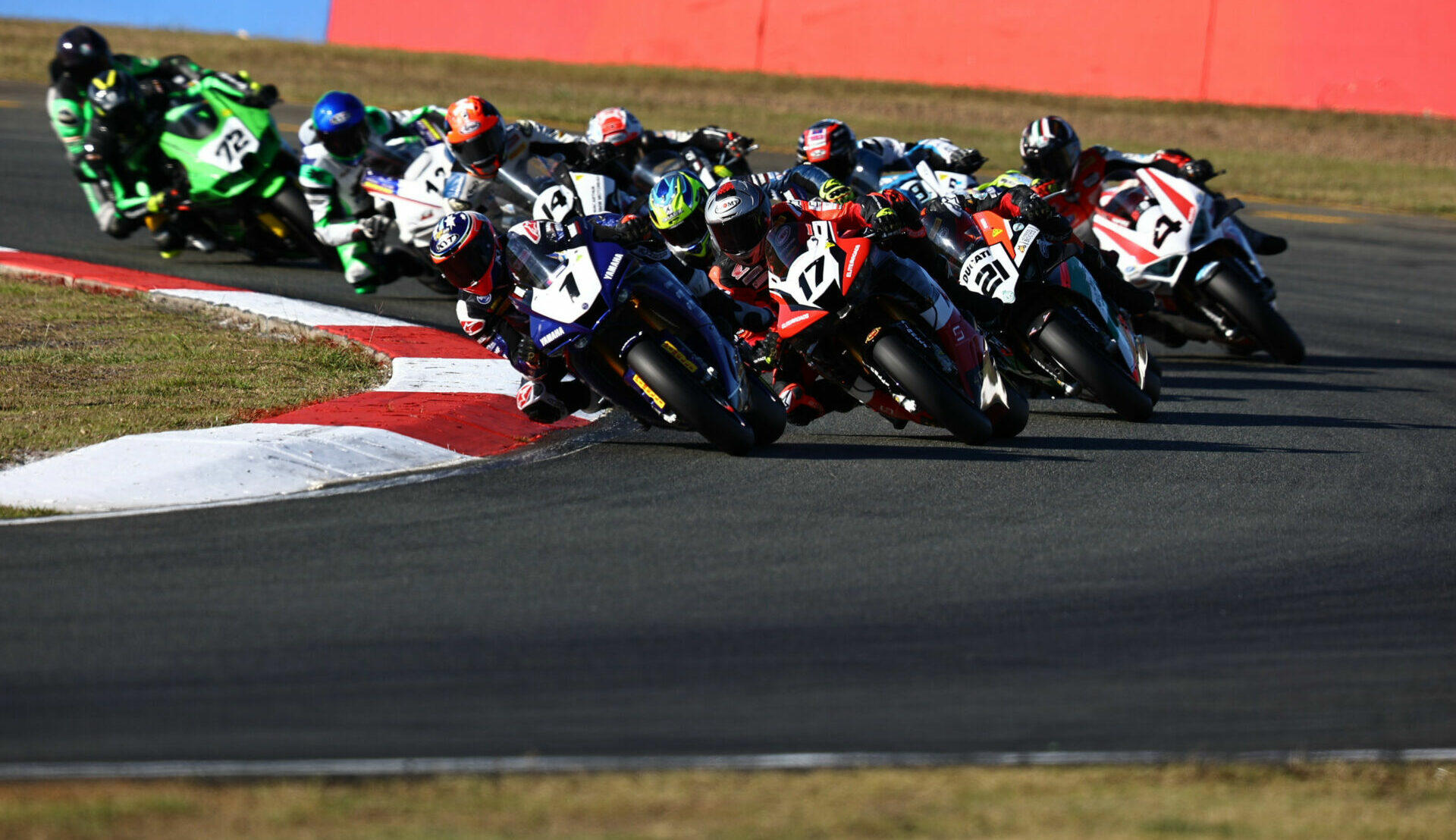 Mike Jones (1) leads Troy Herfoss (17) and the rest of the field into Turn One at Queensland Raceway. Photo courtesy ASBK.