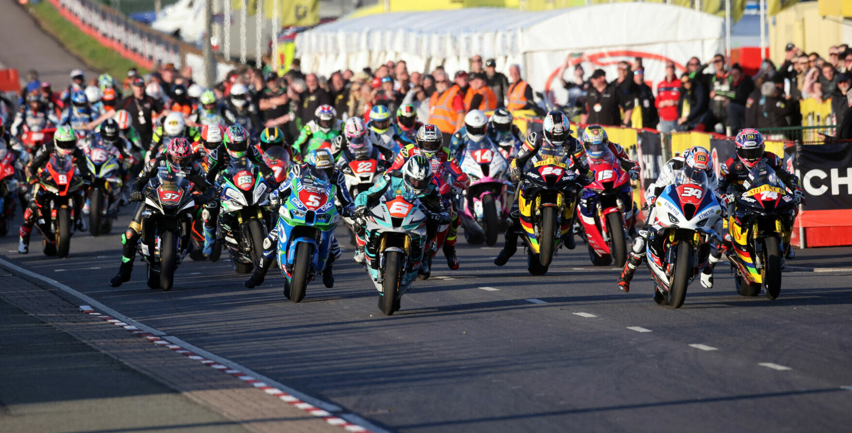 The start of the Superstock race Thursday evening at the North West 200. Alastair Seeley (34), Davey Todd (74), and Michael Dunlop (6) lead the field off the grid. Photo courtesy NW200 Press Office.
